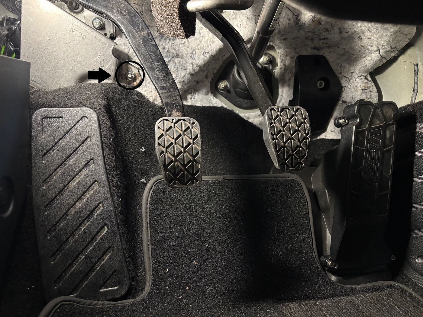 Driver's footwell with the mounting stud circled